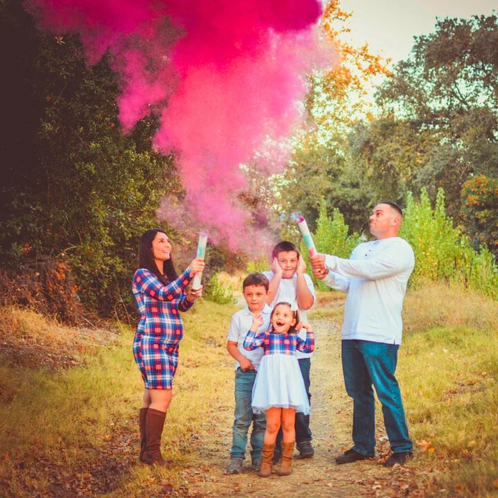 Happy family using a gender reveal smoke cannon