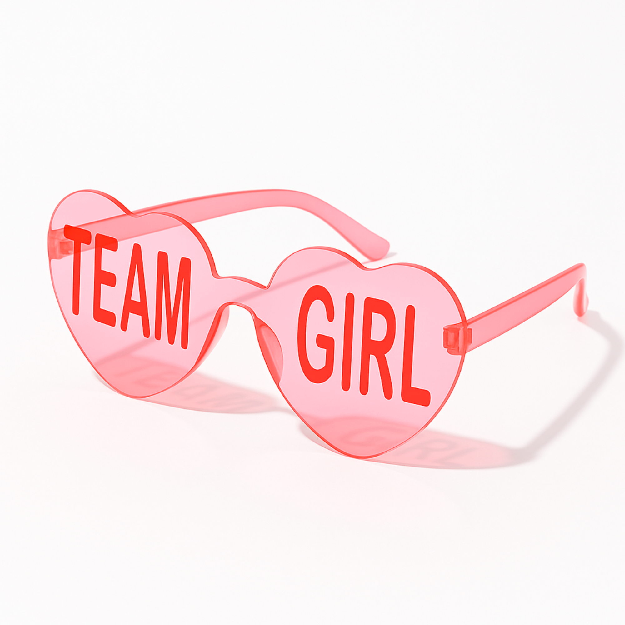 Pink heart-shaped Team Girl glasses for gender reveal or baby shower decorations, shown on a white background.